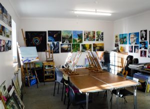 Art studio room with painting hanging on the walls