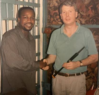 John Oboh next to Norman MacLeod shaking hands